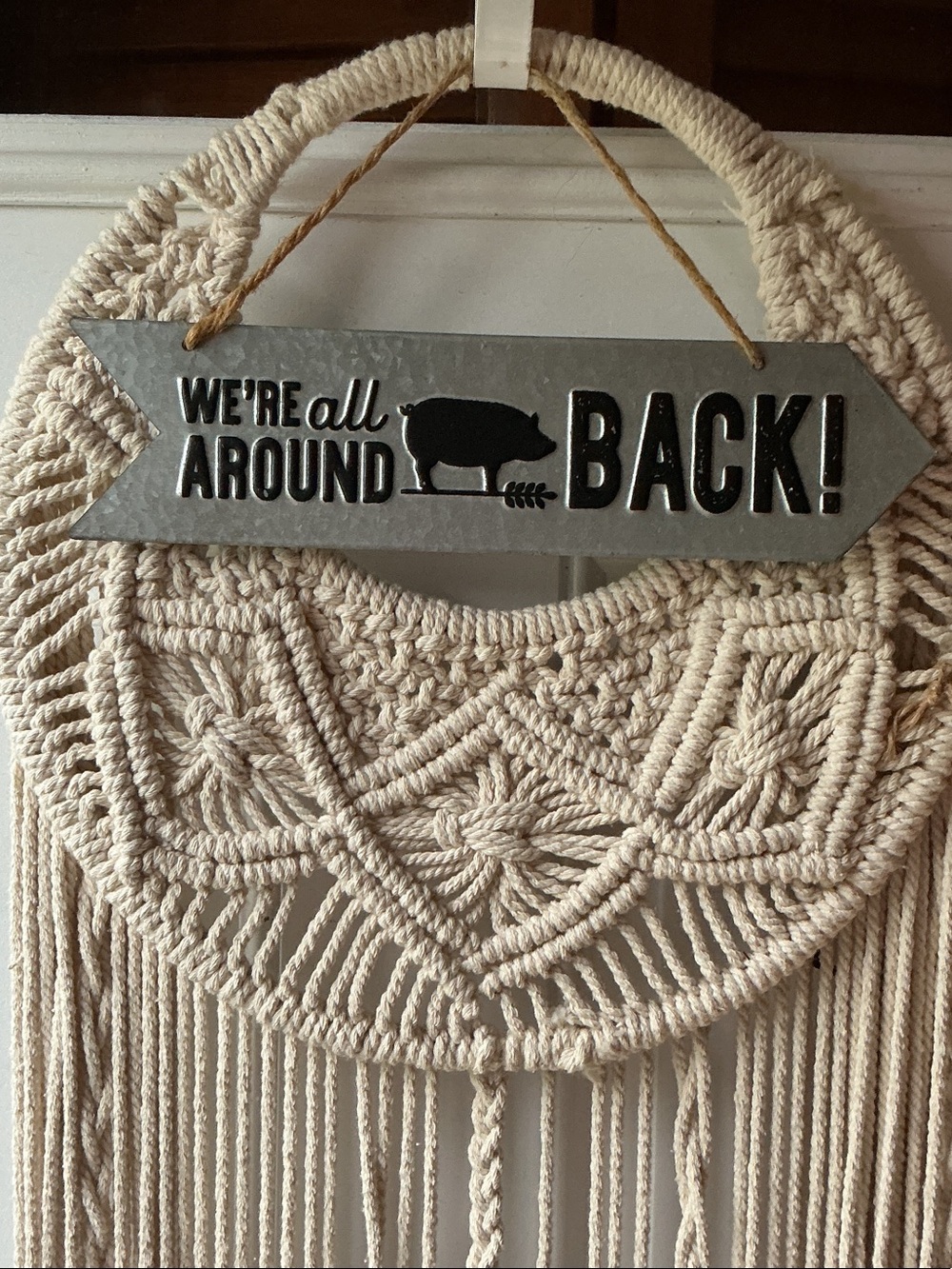 Rustic 'We're All Around Back!' Metal Wall Sign with Beige Macramé